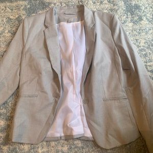 Light grey blazer with white lining on the inside